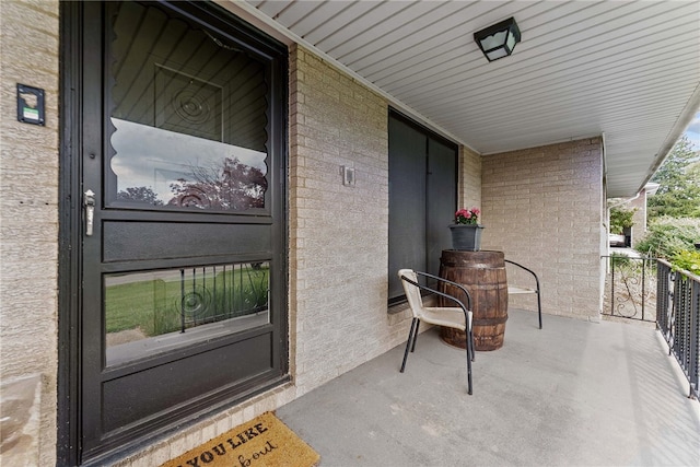 doorway to property featuring brick siding