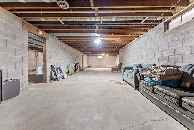 unfinished below grade area featuring concrete block wall