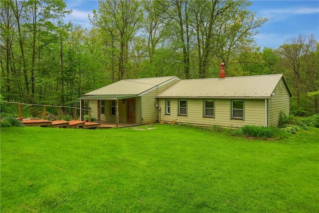 138 Bovard Ln, Cherry Twp, PA 16020 - view of front facade featuring a front lawn, metal roof, and a deck