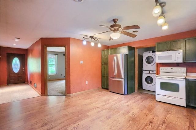 138 Bovard Ln, Cherry Twp, PA 16020 - kitchen with white appliances, stacked washer / dryer, green cabinetry, ceiling fan, and light wood-style floors