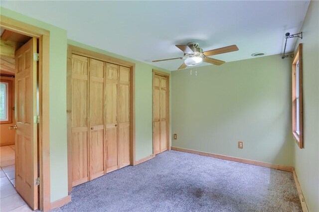 138 Bovard Ln, Cherry Twp, PA 16020 - unfurnished bedroom featuring multiple closets, light carpet, baseboards, and a ceiling fan