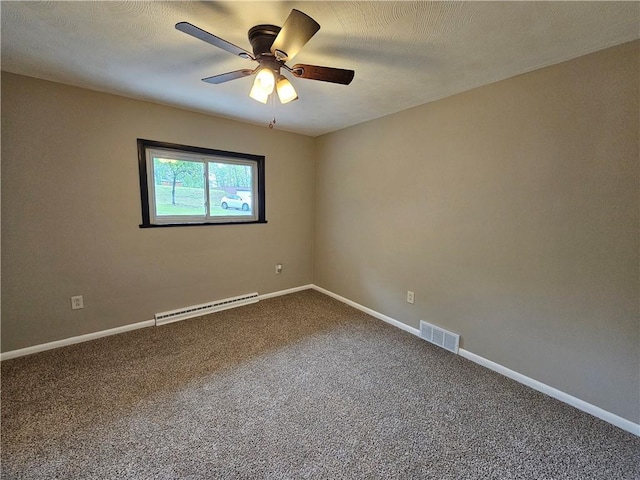 empty room featuring a baseboard heating unit, dark colored carpet, ceiling fan, and baseboards