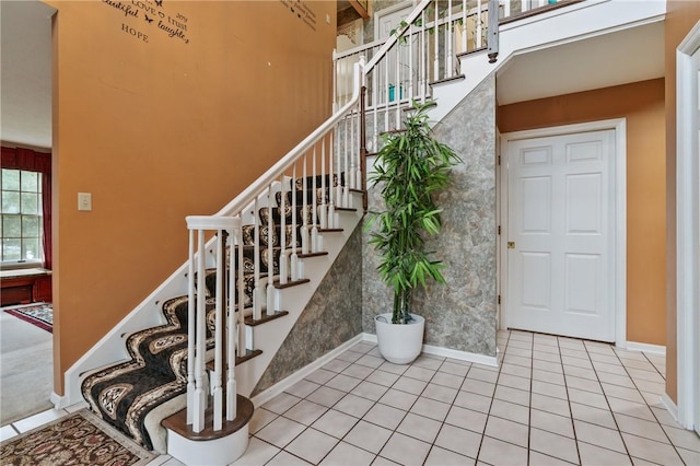 228 Meadowfield Ln, Jefferson Hills, PA 15025 - stairway featuring baseboards, tile patterned flooring, and a towering ceiling