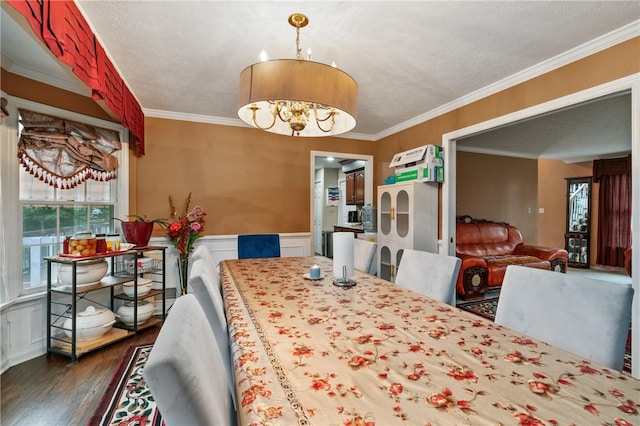 228 Meadowfield Ln, Jefferson Hills, PA 15025 - dining room featuring dark wood finished floors, crown molding, a chandelier, wainscoting, and a decorative wall