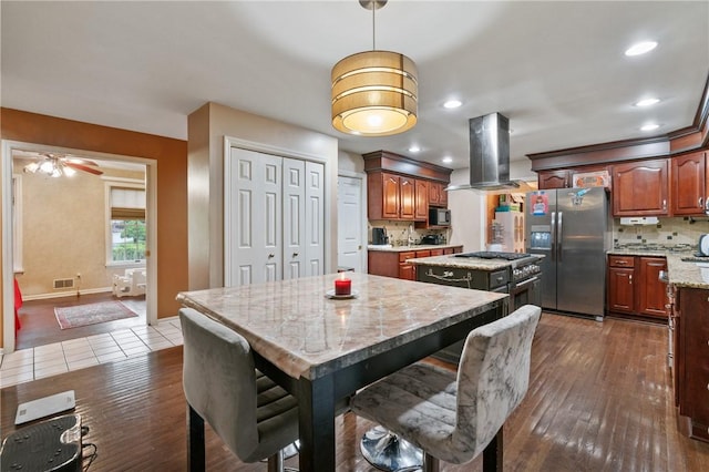 228 Meadowfield Ln, Jefferson Hills, PA 15025 - kitchen featuring appliances with stainless steel finishes, a center island, island exhaust hood, dark wood-type flooring, and decorative backsplash