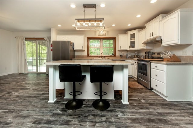 529 Mill Creek Rd, Mill Creek, PA 16362 - kitchen with appliances with stainless steel finishes, under cabinet range hood, white cabinets, a kitchen island, and recessed lighting