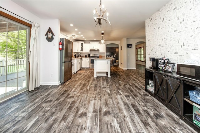 529 Mill Creek Rd, Mill Creek, PA 16362 - kitchen with appliances with stainless steel finishes, arched walkways, a chandelier, dark wood-style flooring, and baseboards