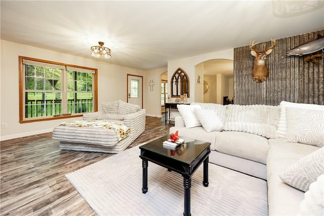 529 Mill Creek Rd, Mill Creek, PA 16362 - living area with arched walkways, baseboards, and wood finished floors
