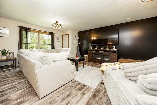 529 Mill Creek Rd, Mill Creek, PA 16362 - living area featuring wood finished floors, a chandelier, and a glass covered fireplace