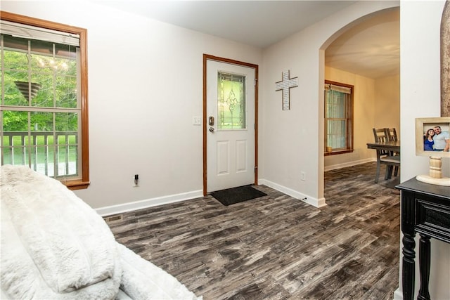529 Mill Creek Rd, Mill Creek, PA 16362 - entrance foyer featuring arched walkways, dark wood finished floors, and baseboards