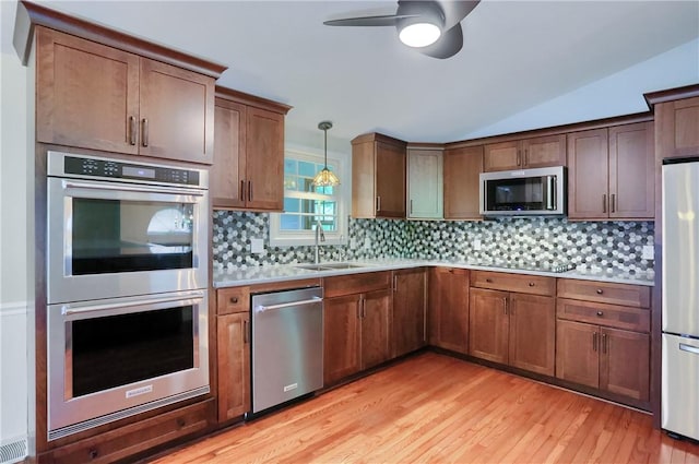122 Oak Ln, North Strabane, PA 15317 - kitchen with appliances with stainless steel finishes, a ceiling fan, light wood-type flooring, light countertops, and a sink