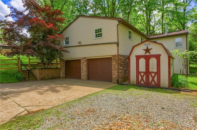 122 Oak Ln, North Strabane, PA 15317 - view of front of home featuring brick siding, concrete driveway, an attached garage, a storage unit, and an outdoor structure