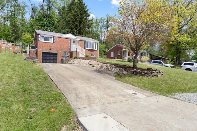 5056 Don St, Finleyville, PA 15332 - ranch-style home with concrete driveway, brick siding, a garage, and a front lawn