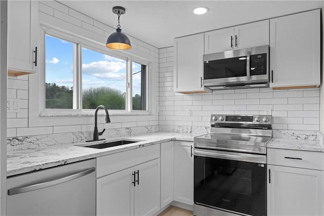 5056 Don St, Finleyville, PA 15332 - kitchen with stainless steel appliances, a sink, white cabinetry, tasteful backsplash, and recessed lighting