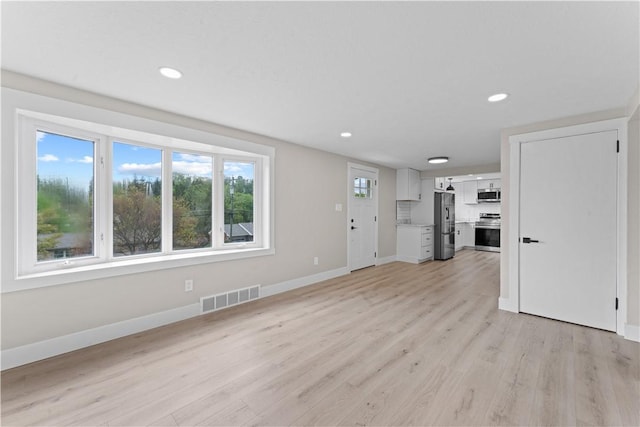 5056 Don St, Finleyville, PA 15332 - unfurnished living room with baseboards, recessed lighting, and light wood finished floors