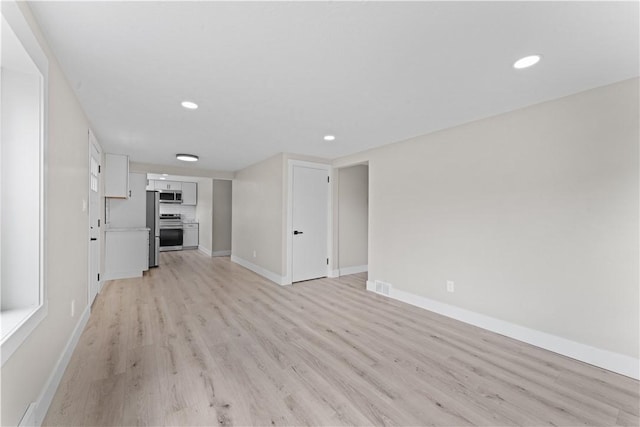 5056 Don St, Finleyville, PA 15332 - unfurnished living room featuring light wood finished floors, baseboards, and recessed lighting