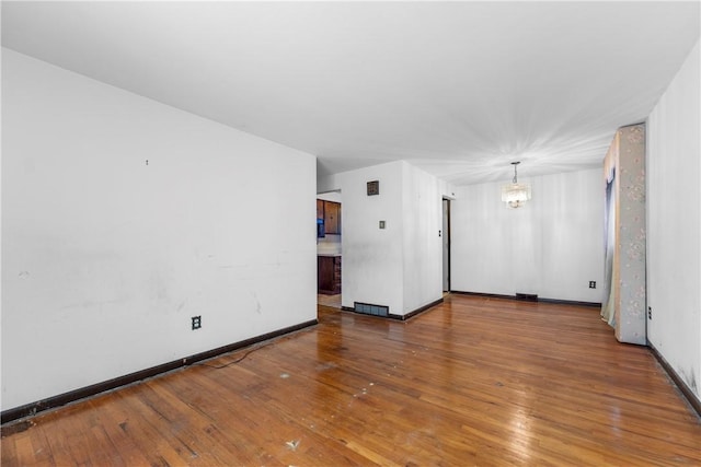 3735 Lyndell St, Castle Shannon, PA 15234 - unfurnished room with a chandelier, hardwood / wood-style flooring, and baseboards