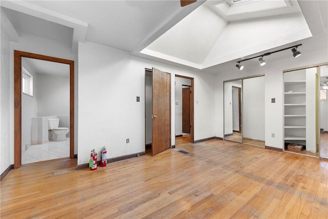 3735 Lyndell St, Castle Shannon, PA 15234 - unfurnished bedroom featuring track lighting, light wood-style floors, baseboards, and two closets
