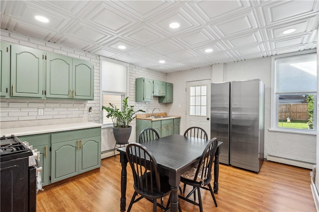 dining space featuring a baseboard heating unit, an ornate ceiling, light wood-type flooring, and recessed lighting