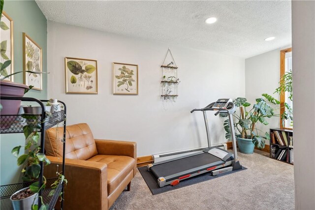 workout area with carpet floors, a textured ceiling, recessed lighting, and a baseboard radiator