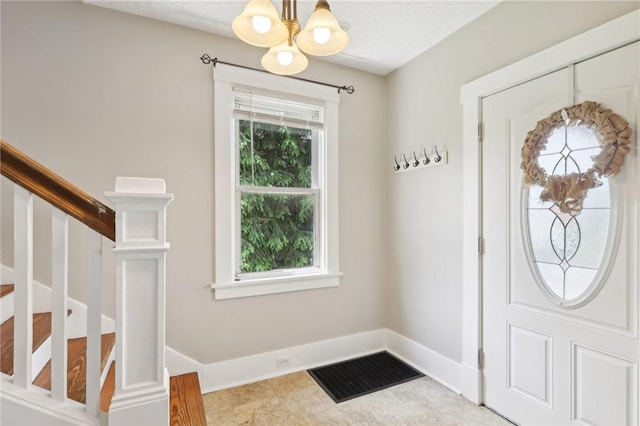 506 7th Ave, Coraopolis, PA 15108 - entrance foyer with a chandelier, baseboards, and stairway