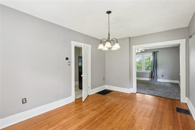 506 7th Ave, Coraopolis, PA 15108 - empty room featuring light wood-style flooring, a chandelier, and baseboards