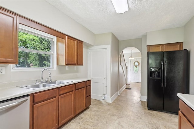 506 7th Ave, Coraopolis, PA 15108 - kitchen with black refrigerator with ice dispenser, dishwasher, a sink, light countertops, and a textured ceiling