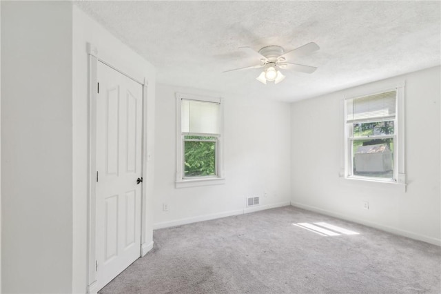 506 7th Ave, Coraopolis, PA 15108 - unfurnished bedroom with carpet, a textured ceiling, baseboards, and ceiling fan