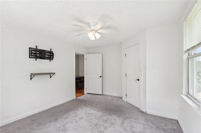 506 7th Ave, Coraopolis, PA 15108 - unfurnished bedroom featuring carpet, multiple windows, baseboards, and a ceiling fan
