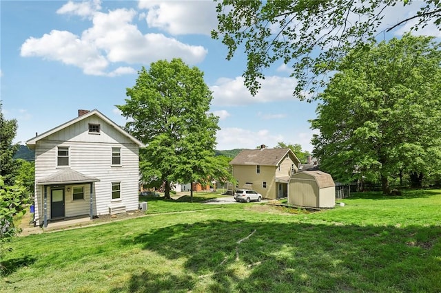 506 7th Ave, Coraopolis, PA 15108 - view of grassy yard with a storage unit and an outbuilding