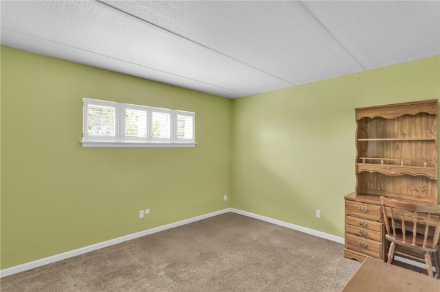 unfurnished office with carpet floors and baseboards