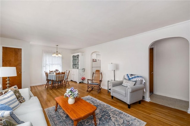 132 W Main St, Greenville Boro Mer, PA 16125 - living room featuring arched walkways, a chandelier, wood finished floors, crown molding, and baseboards
