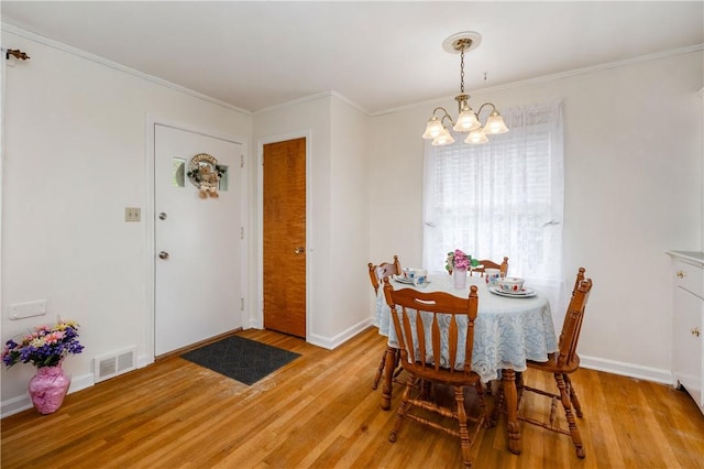 132 W Main St, Greenville Boro Mer, PA 16125 - dining area with light wood-type flooring, a chandelier, baseboards, and ornamental molding