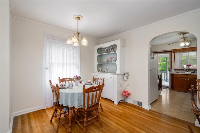 132 W Main St, Greenville Boro Mer, PA 16125 - dining space featuring a chandelier, arched walkways, crown molding, baseboards, and ceiling fan