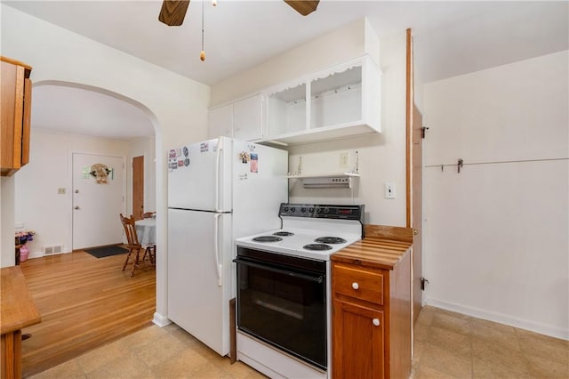 132 W Main St, Greenville Boro Mer, PA 16125 - kitchen featuring electric range oven, arched walkways, freestanding refrigerator, ceiling fan, and light countertops