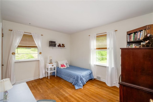 132 W Main St, Greenville Boro Mer, PA 16125 - bedroom featuring multiple windows, light wood-type flooring, and baseboards
