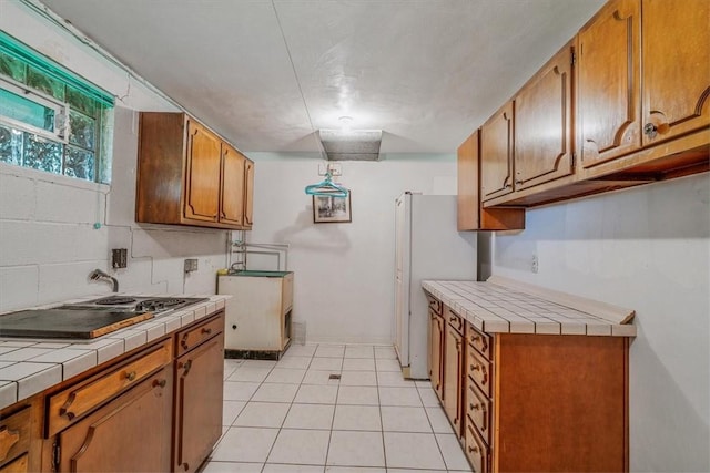2652 Thorntree Dr, Upper St Clair, PA 15241 - kitchen with tile counters, electric stovetop, brown cabinets, freestanding refrigerator, and light tile patterned floors