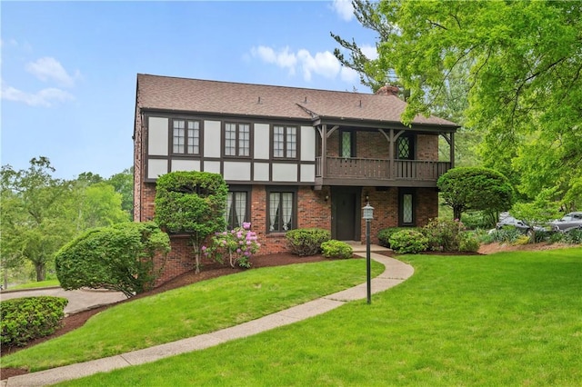 677 Harrogate Rd, Upper St Clair, PA 15241 - rear view of property featuring a lawn, brick siding, a chimney, and a balcony