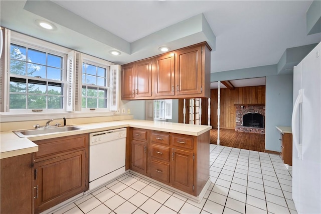 677 Harrogate Rd, Upper St Clair, PA 15241 - kitchen featuring white appliances, a sink, a fireplace, light countertops, and wooden walls