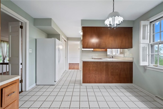 677 Harrogate Rd, Upper St Clair, PA 15241 - kitchen with freestanding refrigerator, a chandelier, light countertops, and a baseboard heating unit