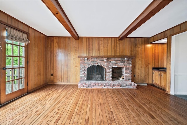 677 Harrogate Rd, Upper St Clair, PA 15241 - unfurnished living room featuring beam ceiling, hardwood / wood-style floors, wood walls, a brick fireplace, and a baseboard heating unit
