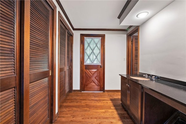 677 Harrogate Rd, Upper St Clair, PA 15241 - entryway featuring a sink, light wood-type flooring, baseboards, and crown molding