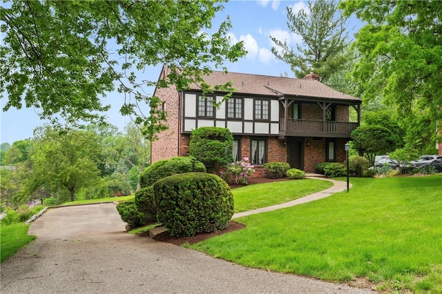 677 Harrogate Rd, Upper St Clair, PA 15241 - tudor-style house with brick siding, a front lawn, a balcony, and a chimney