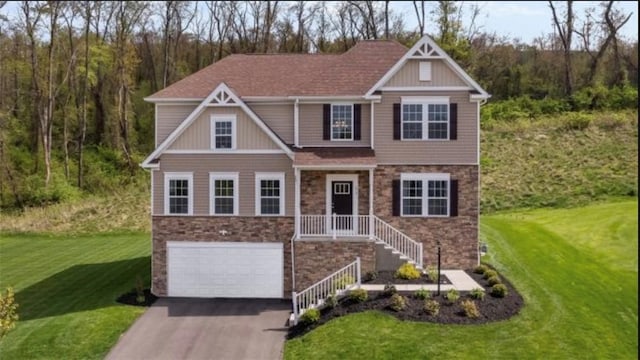 craftsman-style home with stone siding, asphalt driveway, an attached garage, and a front lawn