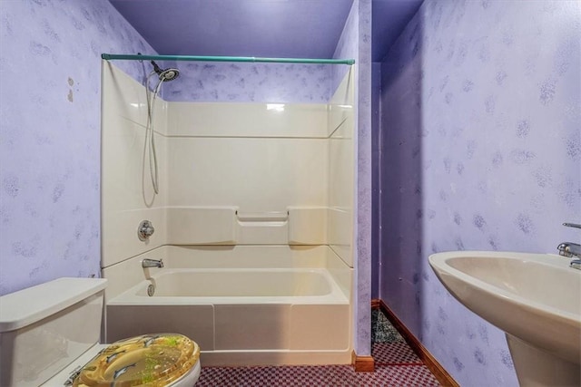 full bathroom featuring toilet, a sink,  shower combination, wallpapered walls, and tile patterned flooring
