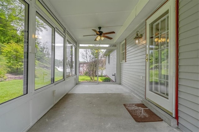 unfurnished sunroom featuring ceiling fan
