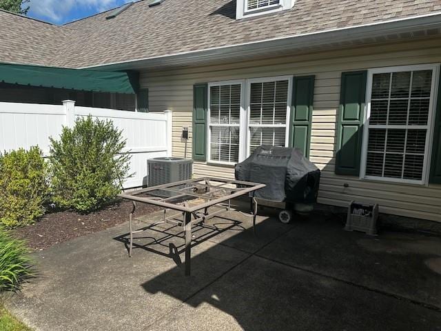 view of patio / terrace featuring fence, central air condition unit, and outdoor dining area