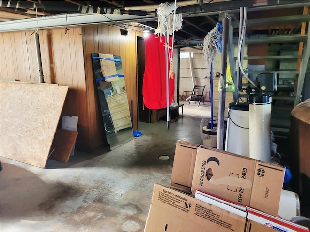 unfinished basement featuring wooden walls