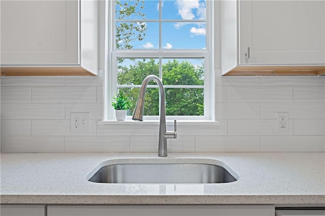 23 Saint Thomas St, South Side, PA 15203 - kitchen featuring a sink, white cabinetry, and backsplash