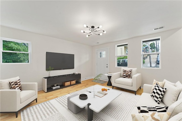 23 Saint Thomas St, South Side, PA 15203 - living room with plenty of natural light, light wood-style floors, and a chandelier